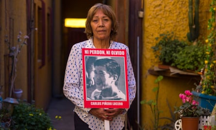 Teresa Berríos carries a photograph of her husband, Carlos