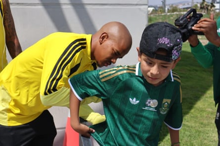 Jayden Adams signs an autograph for a young Mexican fan who arrived at the team’s World Cup hotel with a South Africa shirt.