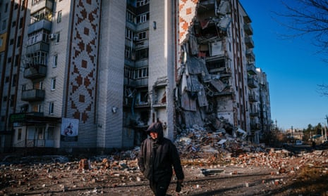 A man walks past by a destroyed residential building in the city of Lyman, Donetsk region, this week
