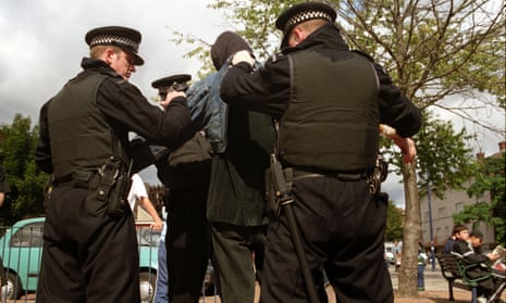 Protester being searched by police at a demonstration against the arms trade in London.