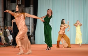 Models in sleek satin dresses throw shapes