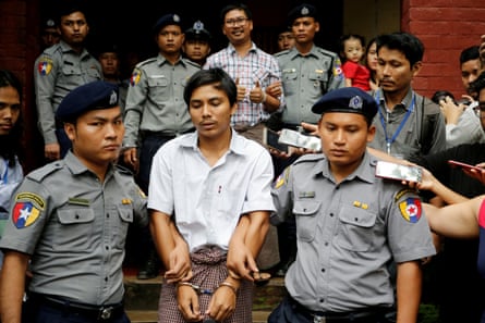 Detained Reuters journalist Kyaw Soe Oo and Wa Lone are escorted by police as they leave after a court hearing in Yangon, Myanmar