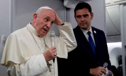 Pope Francis answers questions after leaving Panama City on 27 January.