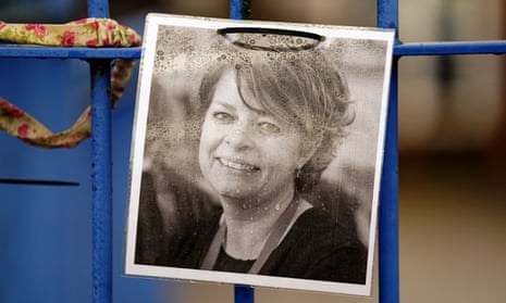 A photograph of headteacher Ruth Perry attached to the railings of a school in Newbury, Berkshire