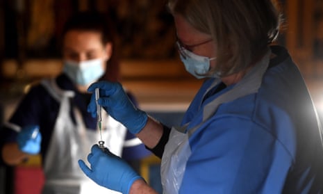 Clinicians prepare Pfizer-BioNTech jabs at a vaccination centre in Salisbury Cathedral.