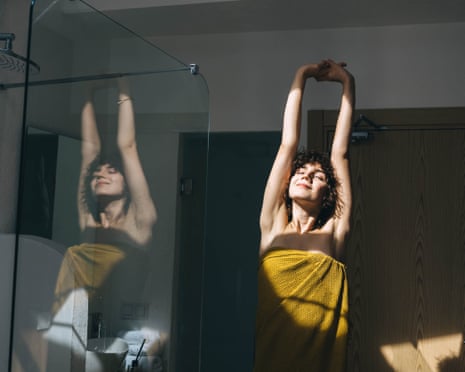A young woman doing morning routine at home before a shower