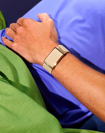 Image of an athlete resting with their hand on their belly and a tracker on their wrist