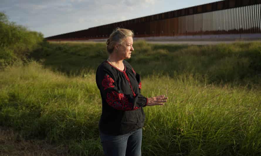 Marianna Treviño-Wright stands near a section of the new border wall in Mission, Texas.