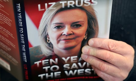 Close up of book with hand on cover featuring title and photo of Liz Truss