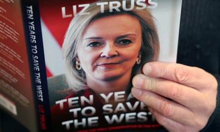 Close up of book with hand on cover featuring title and photo Liz Truss