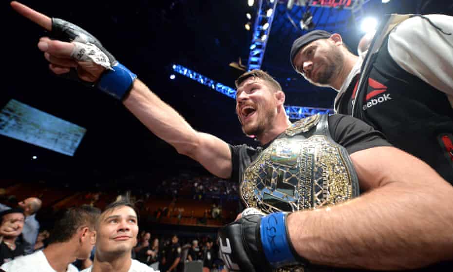 Michael Bisping celebrates with his title belt after his first round knockout win against Luke Rockhold