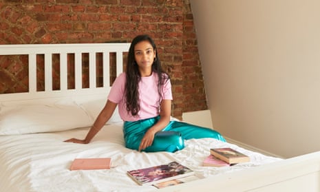 Ruchira Sharma sitting on her bed with magazines and diaries in front of her