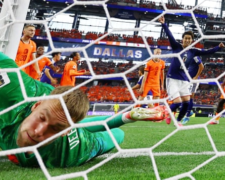 Japan’s Daichi Kamada celebrates scoring their late equaliser past the helpless Netherlands goalkeeper Bart Verbruggen.