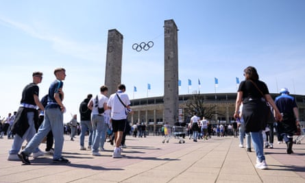 Fans approach the stadium.