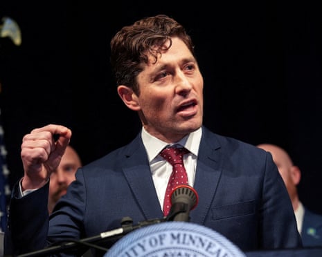 Man in suit gesturing at lectern