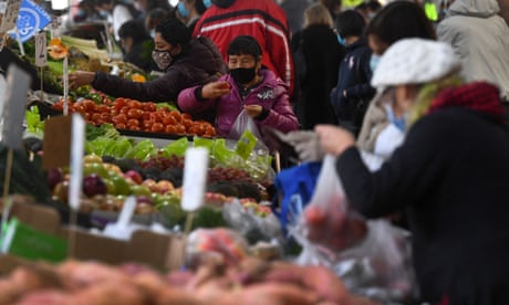 People shop for fruit and vegetables at a market 