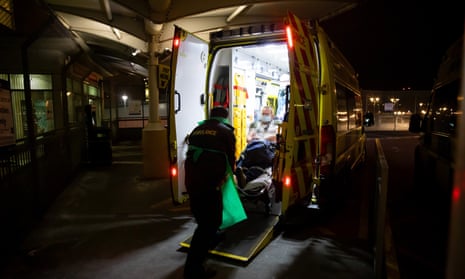 A patient is stretchered out of an ambulance at the emergency department of University Hospital, Coventry, during the coronavirus pandemic