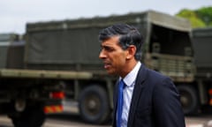 Rishi Sunak gives a statement in front of an army troop carrier