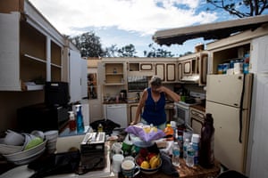a person stands in the middle of a kitchen with a missing roof