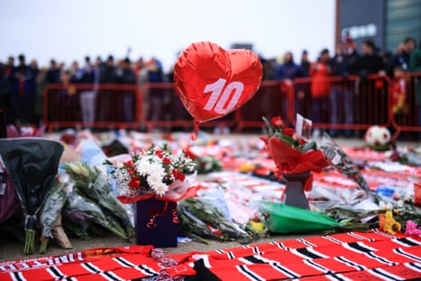 Scarves and wreaths are laid outside Old Trafford as part of the tributes to Denis Law before the match between Manchester United and Brighton
