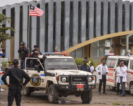 Liberian police officers and medical staff on duty at an airport