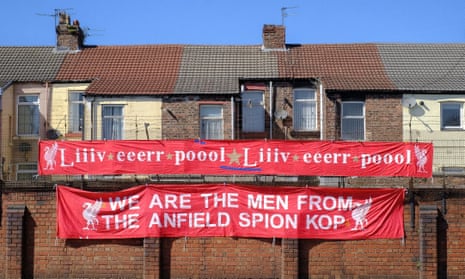 Peter Carney shows off two of his banners in Liverpool. Photo by Jack Finnigan.