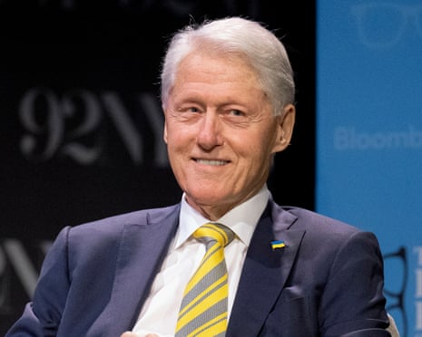Bill Clinton dressed in a suit and sitting down