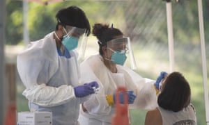 Medical technicians perform Covid-19 tests to Austin residents in a public park last week.