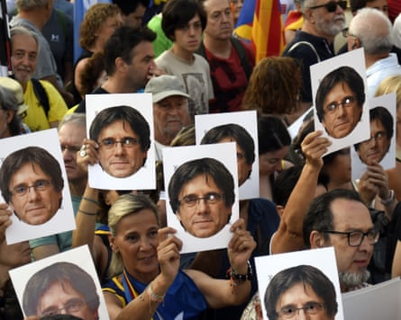 Supporters of former Catalan president Carles Puigdemont listen to a public address in Barcelona in August last year.