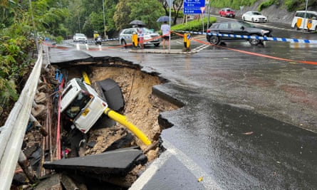 A vehicle in a collapsed section of road in Hong Kong on Friday