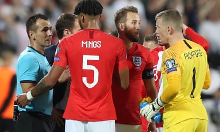 England players discuss whether to continue last week’s game with the referee.