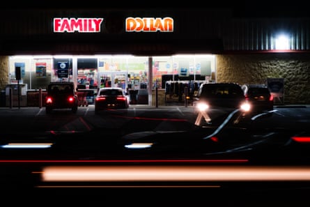 an exterior of a store with cars parked in front