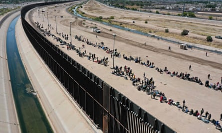 People at the US-Mexico border wall in El Paso, Texas, in May this year, waiting to be processed by US Border Patrol agents.