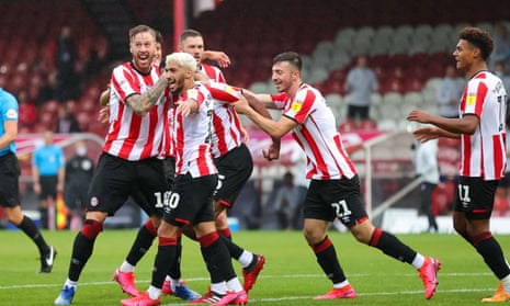Brentford players celebrate after Ethan Pinnock (No 5, obscured) headed home the winner against Charlton.