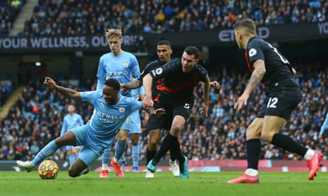 Michael Keane of Everton tackles Raheem Sterling of Manchester City. A penalty is given, but later overturned after VAR.