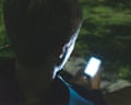 Teenager with phone at night
