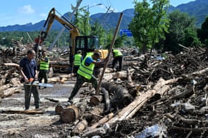 Workers clear debris after floods in Miyun district, northern Beijing