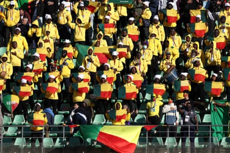 Benin's supporters hold flags during the Africa Cup of Nations round of 16 match against Egypt.
