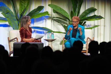 two women sit on stage