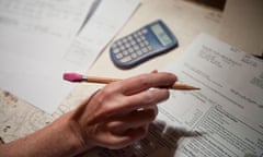 Close up of a woman's hand sorting through bills.