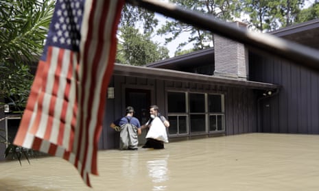 A flooded home in Houston, with tattered US flag