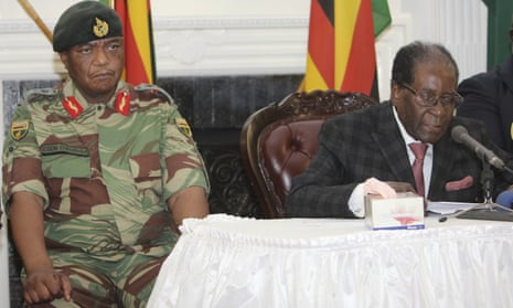 Zimbabwean President Robert Mugabe flanked by the Army Chief Chiwenga delivers his speech during a live broadcast at State House in Harare