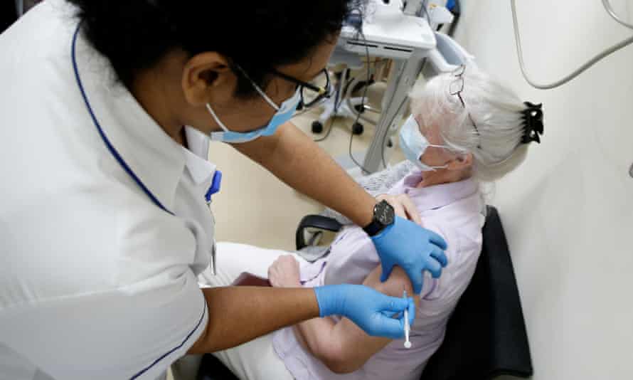 A woman receives a dose of the Pfizer-BioNTech COVID-19 vaccine at Zabeel Health Center in Dubai, United Arab Emirates.