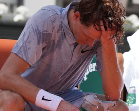 Jannik Sinner of Italy reacts as he cools himself with the water during a break at the second round men’s singles tennis match