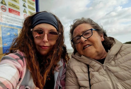 A woman in dark glasses posing for a selfie with her mother