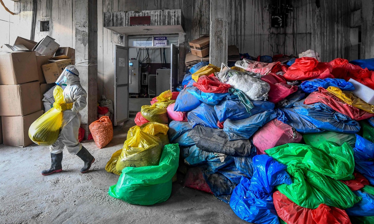 A worker at a hospital in Kathmandu, Nepal, readies bags of Covid-19 waste for treatment, December last year. 
