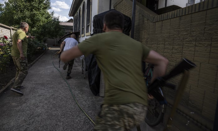 Ukrainian Muslim soldiers run to a bomb shelter in a mosque during shelling in Konstantinovka, eastern Ukraine