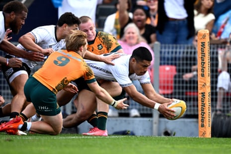 Salesi Rayasi of Fiji scores a try on debut.