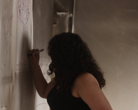 Young woman writes on wall