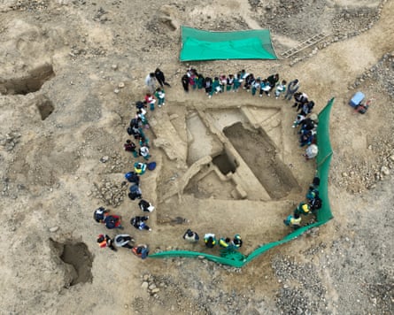 people standing around an excavation site